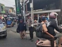 Polri Bersama Masyarakat Anggota Satlantas Bulukumba Bantu Seorang Nenek Nyeberang Jalan